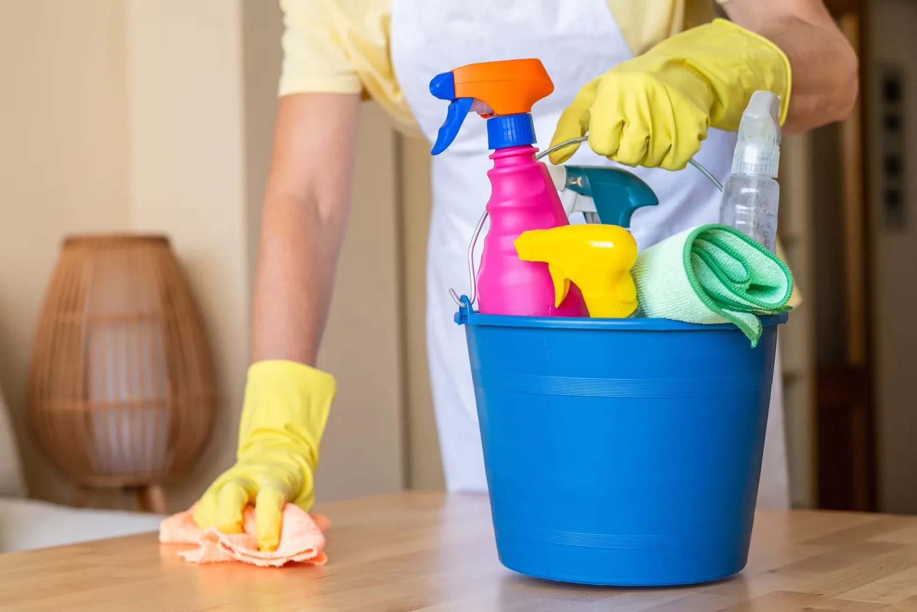 A residential cleaner carrying supplies through a well-kept home